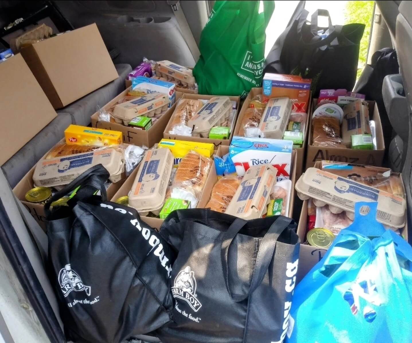 A vehicle filled with food donations ready for delivery